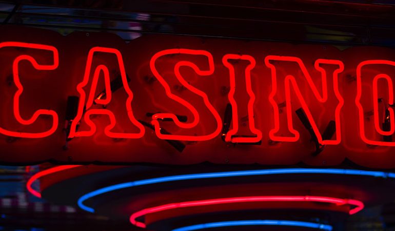 red neon lights with the word "Casino"